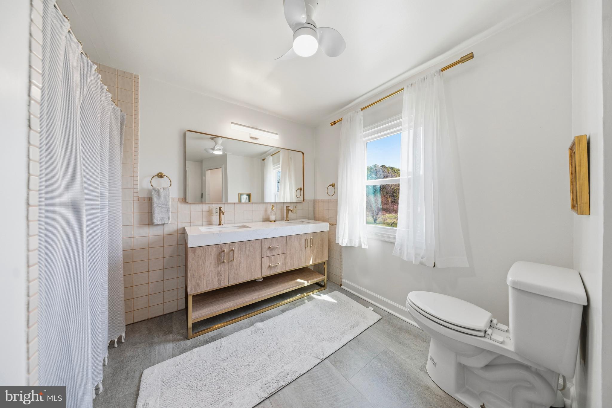 20826 Bivalve Wharf Road Bivalve, MD 21865 - Photo 36 of 52 a bathroom with a sink vanity mirror and toilet