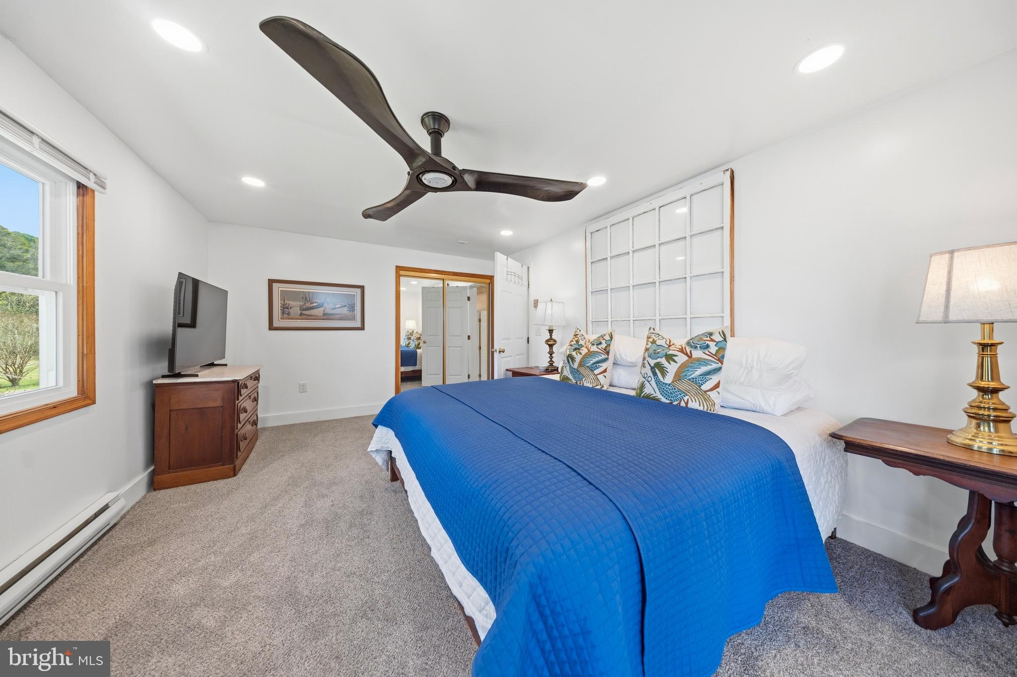 20826 Bivalve Wharf Road Bivalve, MD 21865 - Photo 40 of 52 a bed room with a bed and a lamp