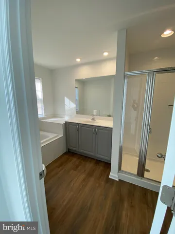 a view of bathroom with a sink and mirror