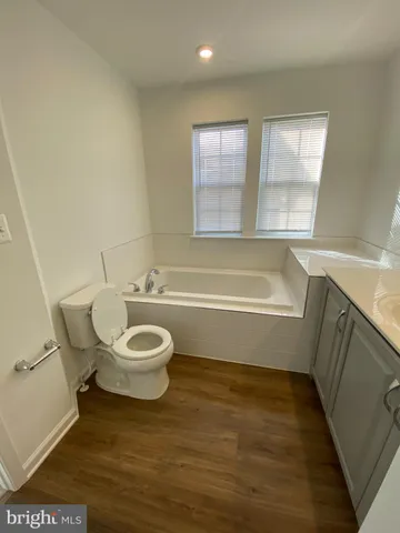 a bathroom with a toilet a sink and bathtub