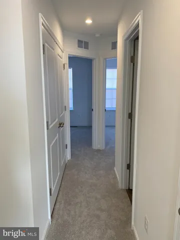 a view of a hallway with wooden shelves