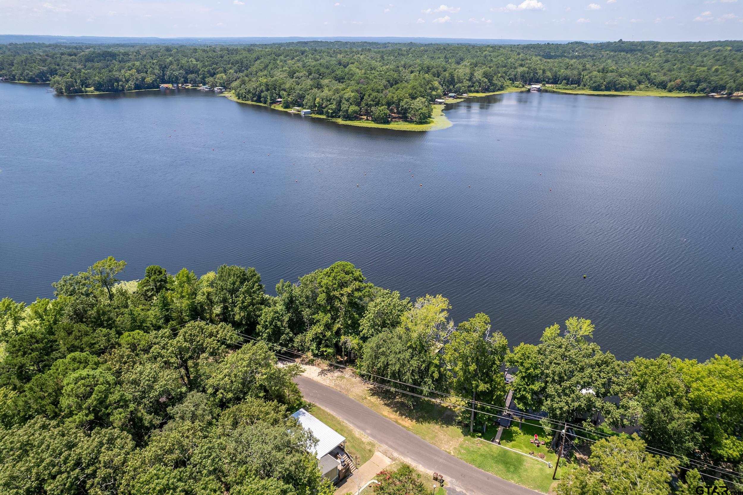 749 County Road 3420 Hawkins, TX 75765 - Photo 1 of 29 a view of a lake with a outdoor space