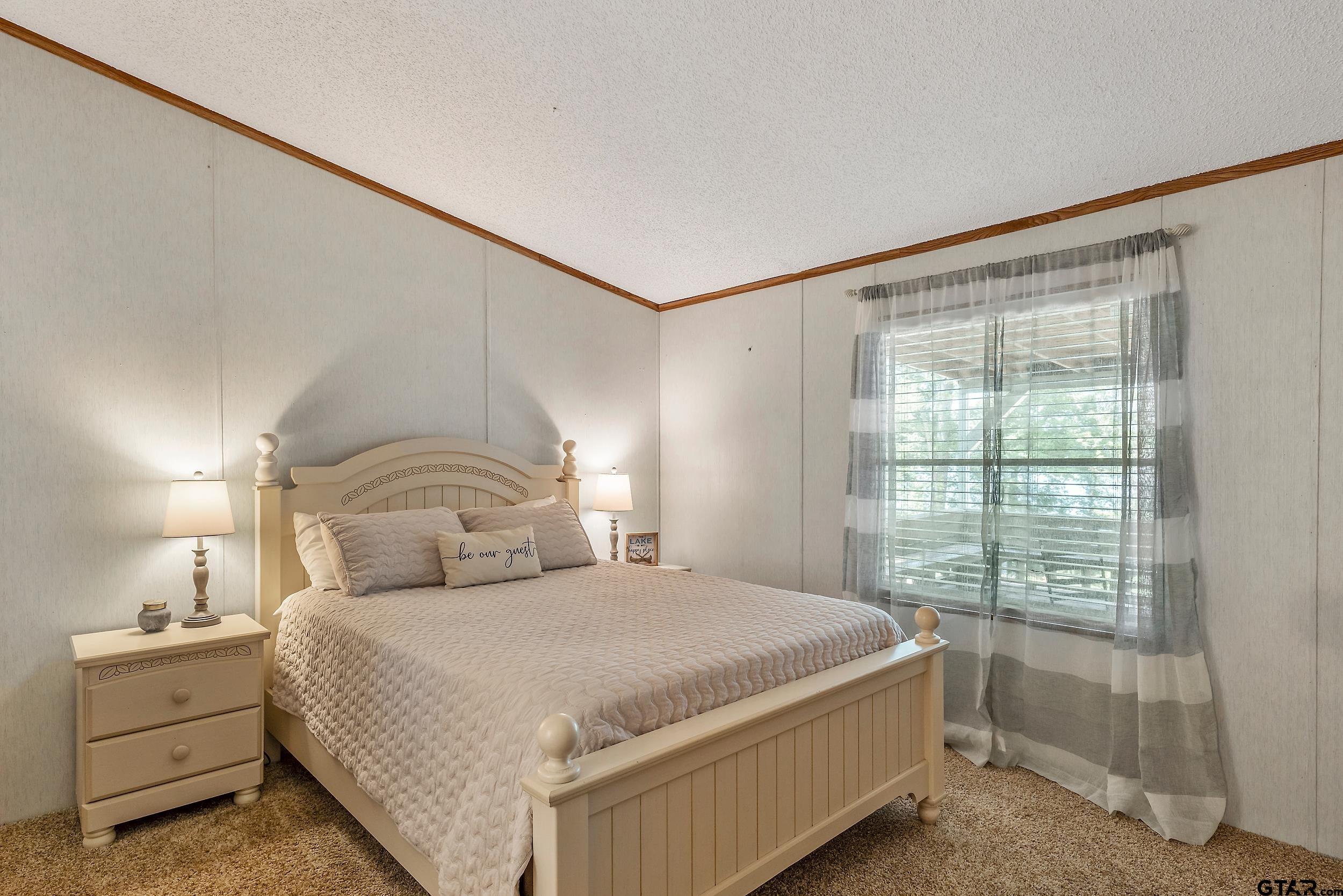 749 County Road 3420 Hawkins, TX 75765 - Photo 15 of 29 a bedroom with a large bed and a window