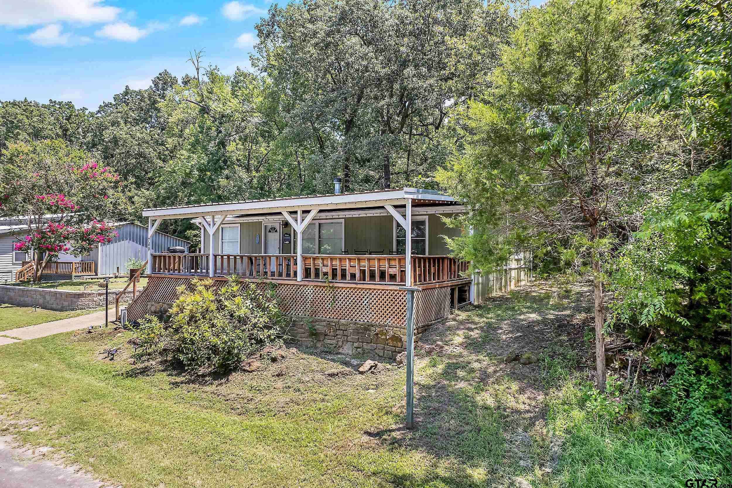 749 County Road 3420 Hawkins, TX 75765 - Photo 2 of 29 a house with trees in the background