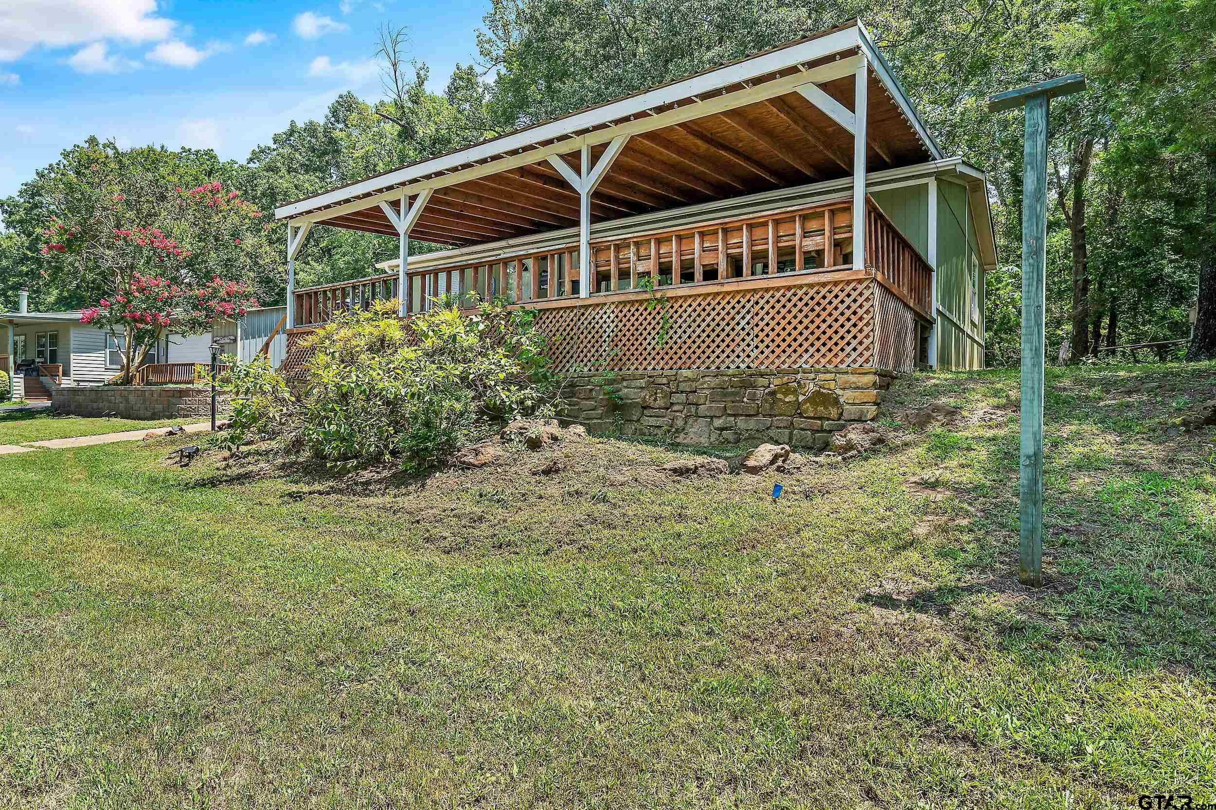 749 County Road 3420 Hawkins, TX 75765 - Photo 28 of 29 a view of house with backyard and trees