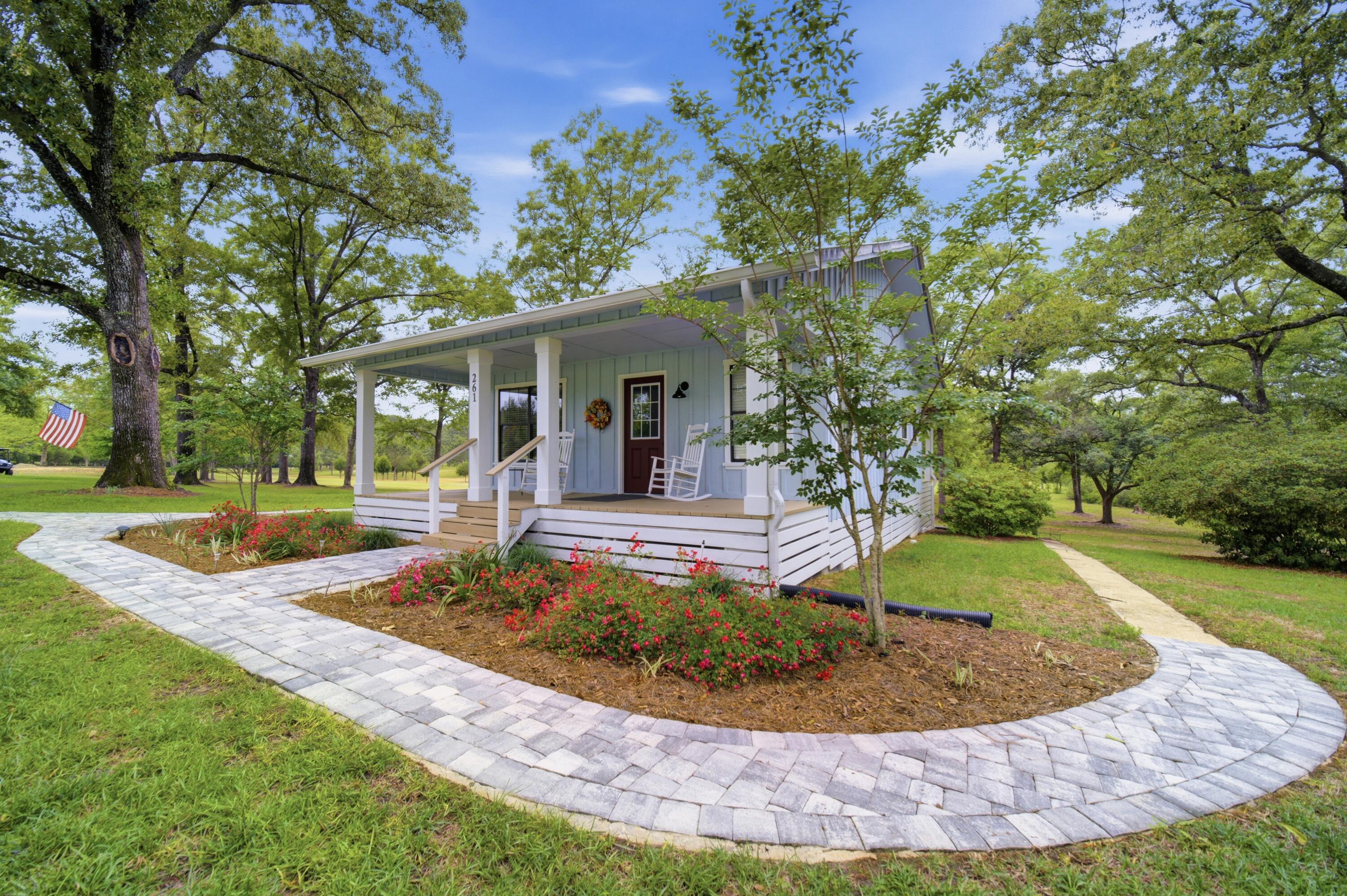 261 Wilkerson Road DeFuniak Springs, FL 32433 - Photo 43 of 76 a view of a house with swimming pool and yard