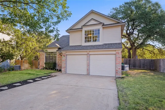 a front view of house with yard and trees