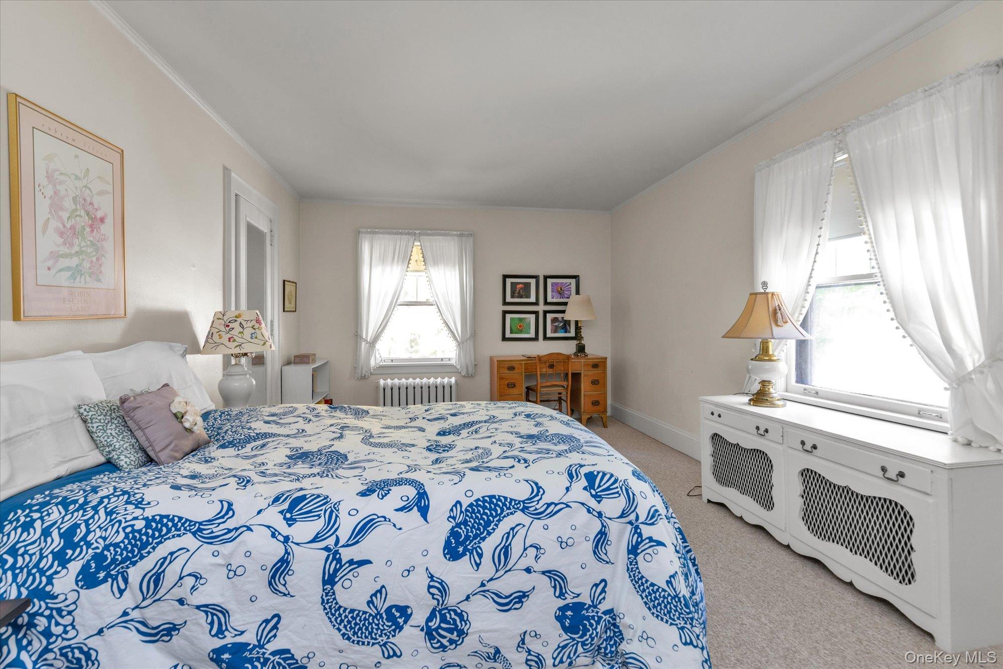 57 Beacon Hill Road Port Washington, NY 11050 - Photo 14 of 25 a bedroom with a bed and a dresser next to a window