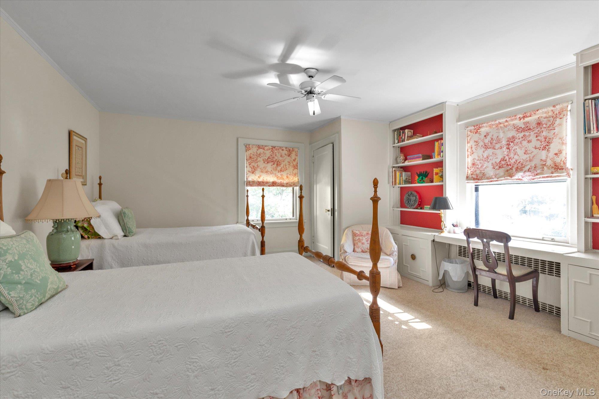 57 Beacon Hill Road Port Washington, NY 11050 - Photo 16 of 25 a bedroom with furniture and a large window