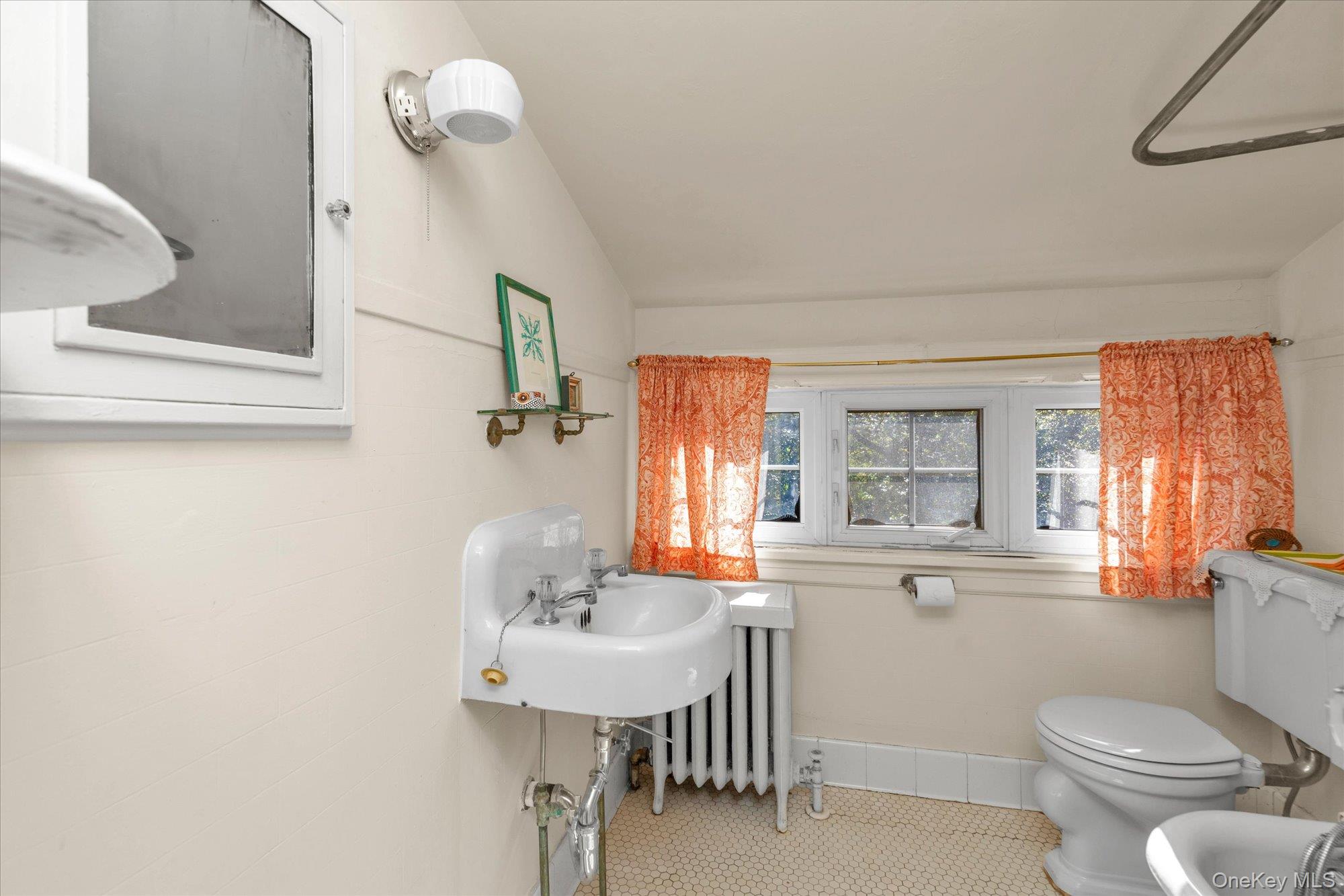 57 Beacon Hill Road Port Washington, NY 11050 - Photo 20 of 25 a bathroom with a toilet sink and mirror
