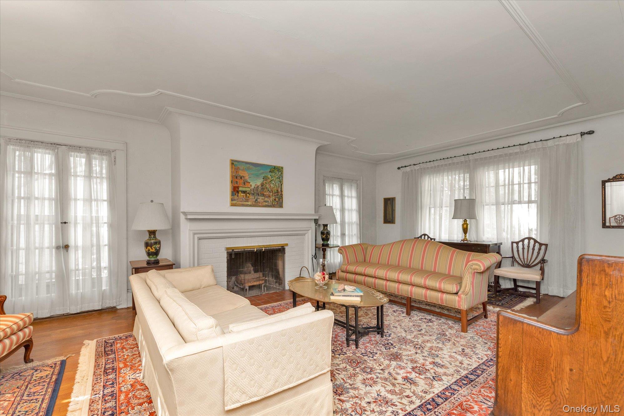 57 Beacon Hill Road Port Washington, NY 11050 - Photo 2 of 25 a living room with furniture and a fireplace