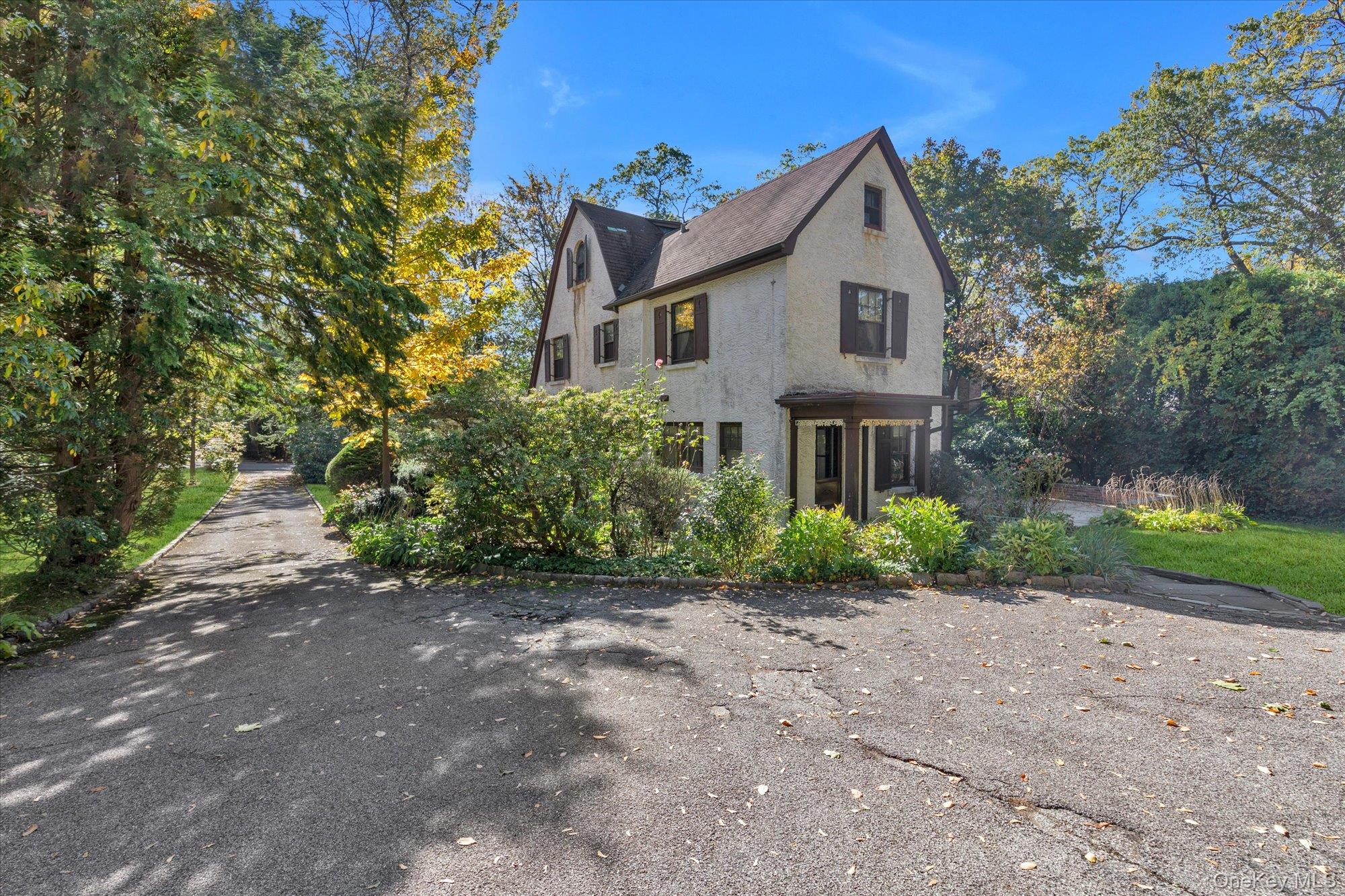 57 Beacon Hill Road Port Washington, NY 11050 - Photo 22 of 25 a front view of a house with garden