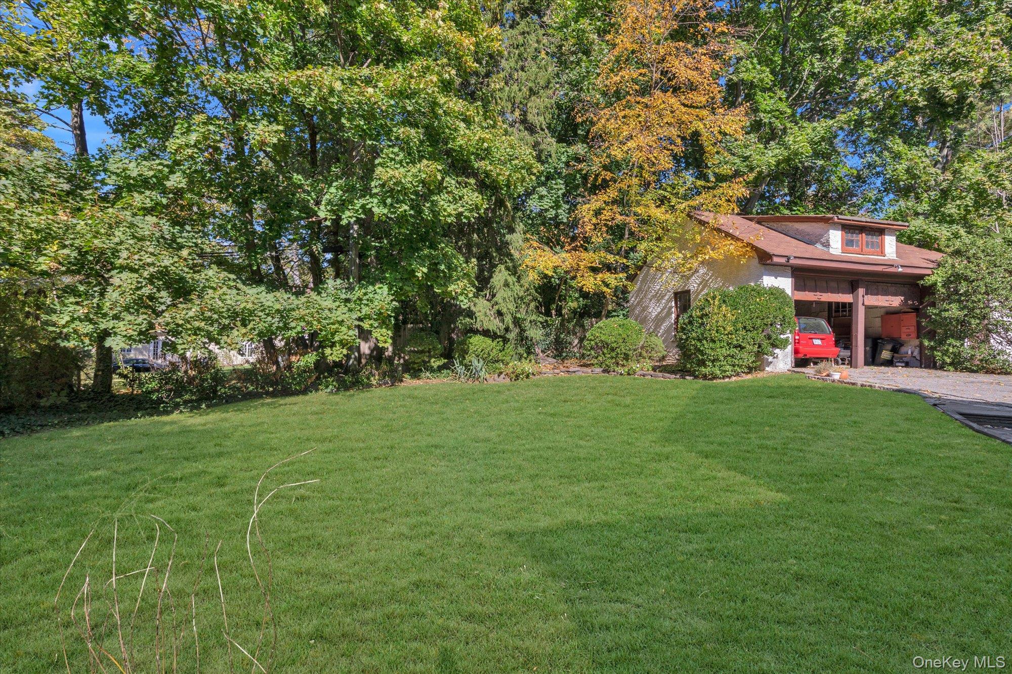 57 Beacon Hill Road Port Washington, NY 11050 - Photo 24 of 25 a view of a white house with a yard