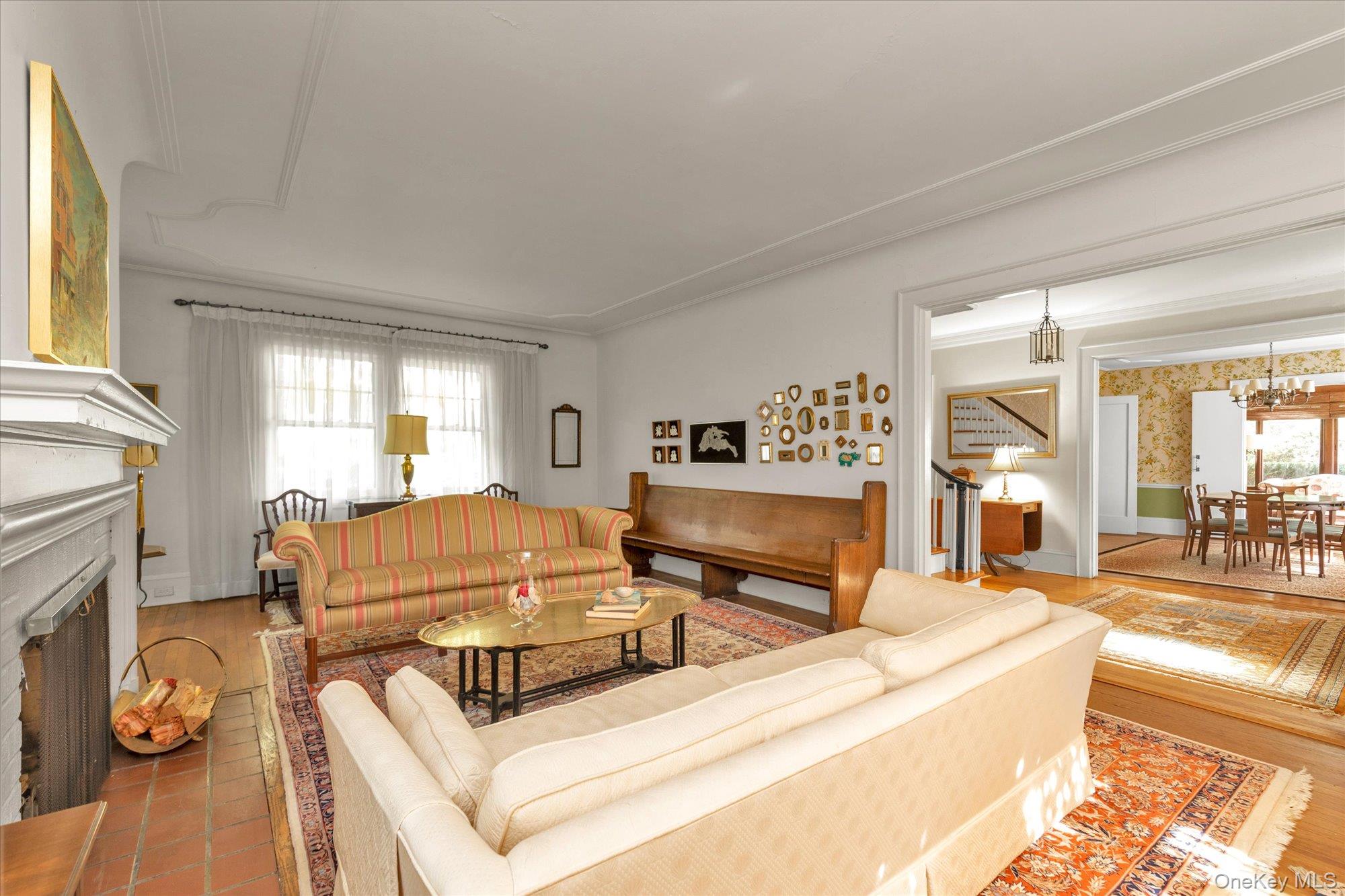 57 Beacon Hill Road Port Washington, NY 11050 - Photo 3 of 25 a living room with furniture and a fireplace