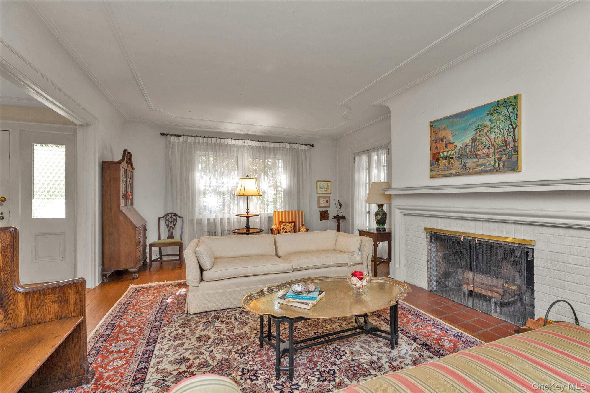 57 Beacon Hill Road Port Washington, NY 11050 - Photo 4 of 25 a living room with furniture and a fireplace