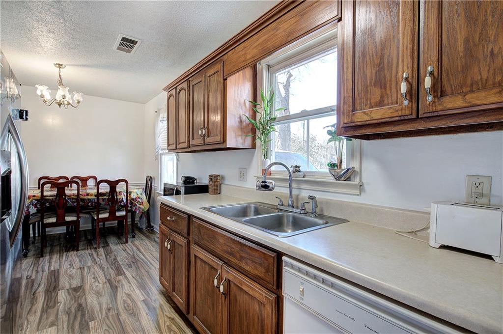 302 Douglas Street Cartersville, GA 30120 - Photo 14 of 29 a kitchen with a sink cabinets and wooden floor