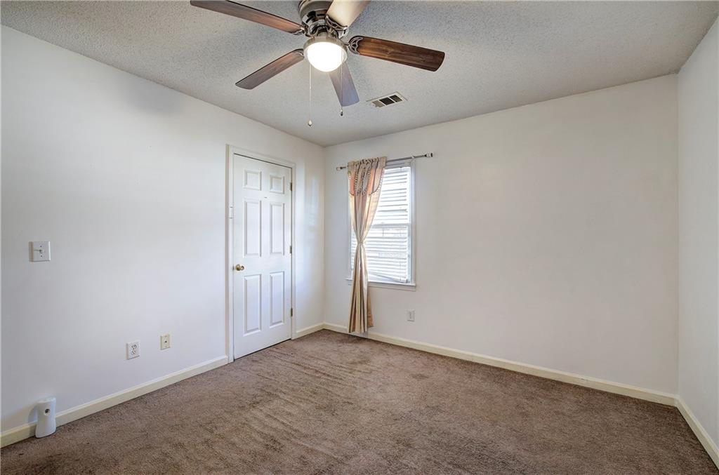 302 Douglas Street Cartersville, GA 30120 - Photo 21 of 29 an empty room with windows and fan