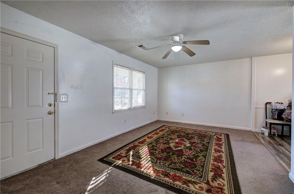 302 Douglas Street Cartersville, GA 30120 - Photo 4 of 29 a view of a room with wooden floor and window