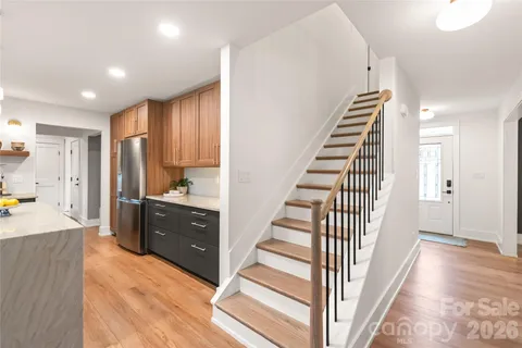 a view of a kitchen with wooden floor and stairs