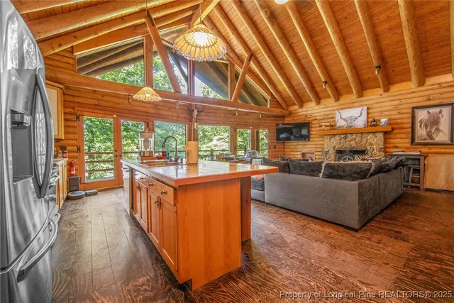 a living room with furniture and a floor to ceiling window