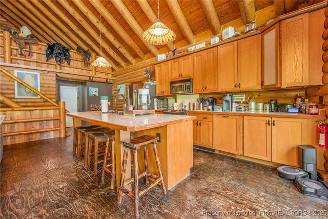 a dining hall with stainless steel appliances a sink and cabinets