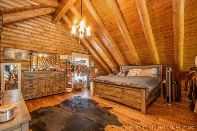 a room with a bed and wooden floor