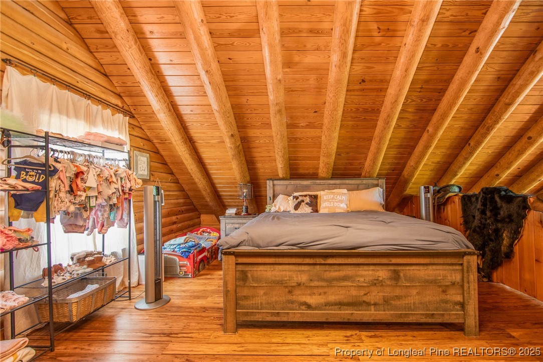 329 Silver Grove Church Road Rockingham, NC 28379 - Photo 19 of 36 a room with a bed and wooden floor