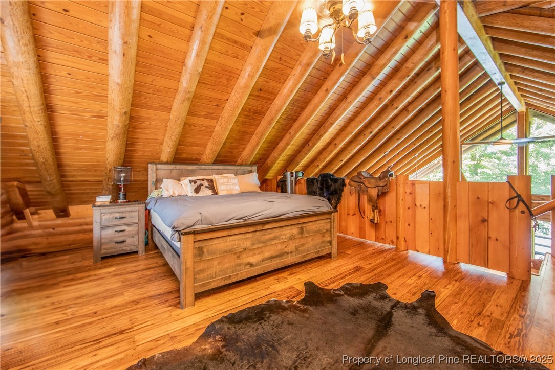 329 Silver Grove Church Road Rockingham, NC 28379 - Photo 20 of 36 a bedroom with a bed and wooden floor