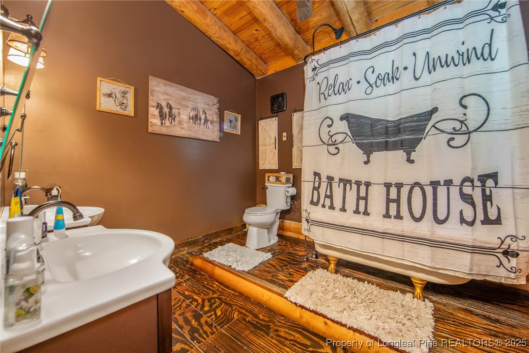 329 Silver Grove Church Road Rockingham, NC 28379 - Photo 21 of 36 a bathroom with a sink and a toilet