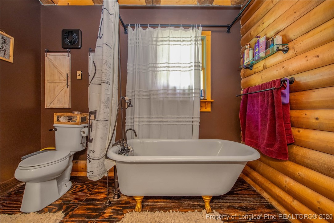 329 Silver Grove Church Road Rockingham, NC 28379 - Photo 23 of 36 a white bath tub sitting next to a toilet