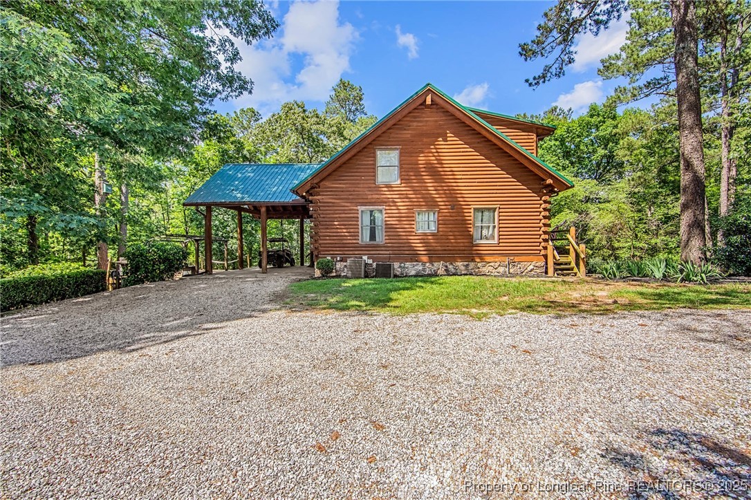 329 Silver Grove Church Road Rockingham, NC 28379 - Photo 30 of 36 a front view of a house with a yard and garage