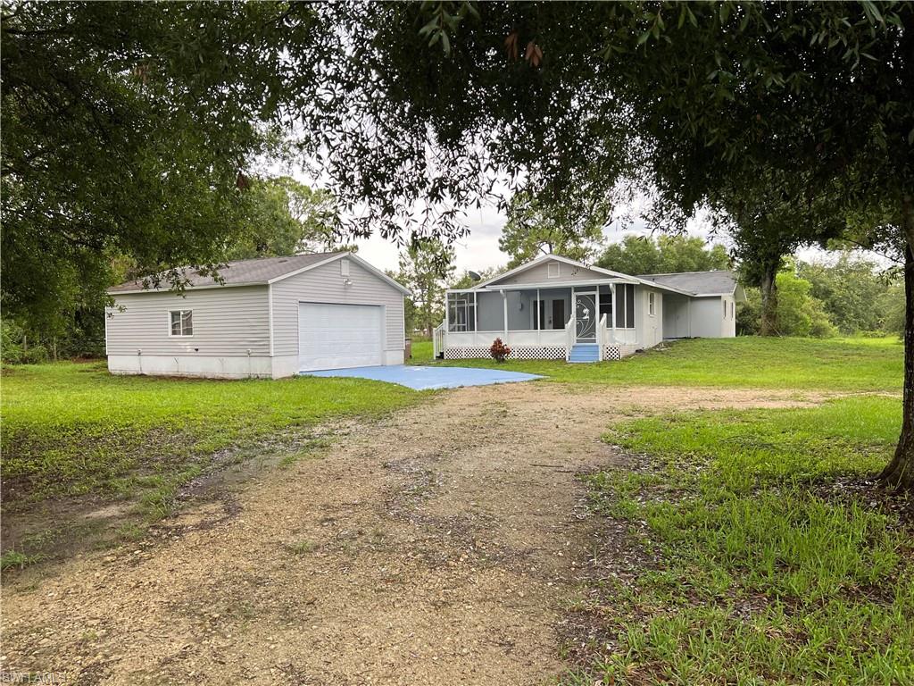 15290 Cemetery Road Fort Myers, FL 33905 - Photo 1 of 13 a view of a house with a yard and sitting area