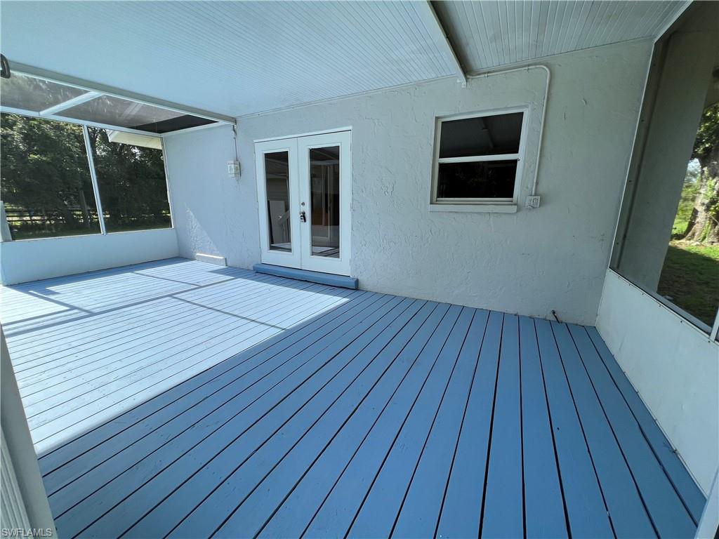 15290 Cemetery Road Fort Myers, FL 33905 - Photo 13 of 13 a view of an empty room with wooden floor and a window