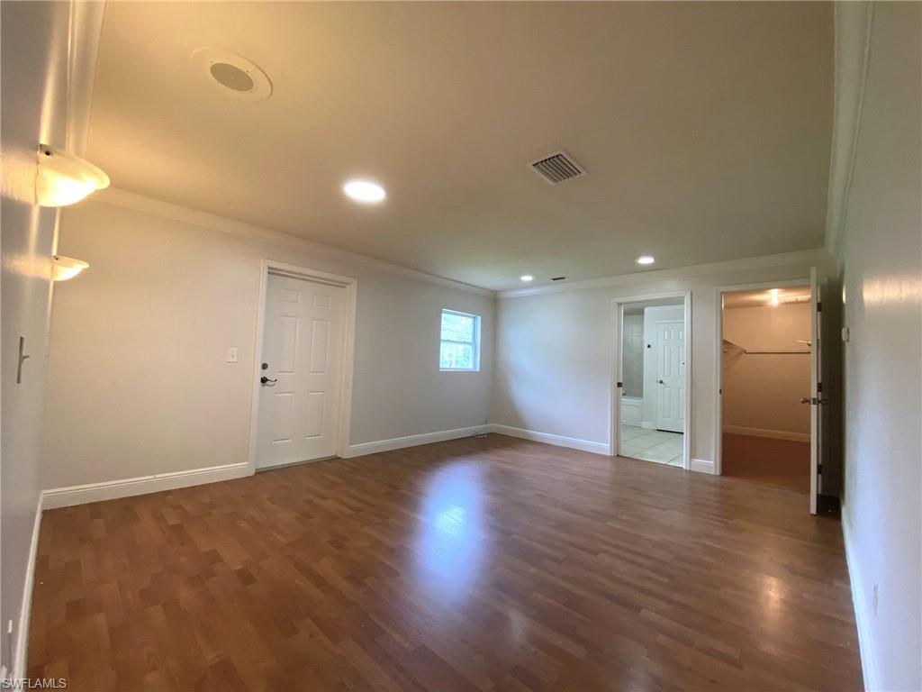 15290 Cemetery Road Fort Myers, FL 33905 - Photo 7 of 13 an empty room with wooden floor and windows