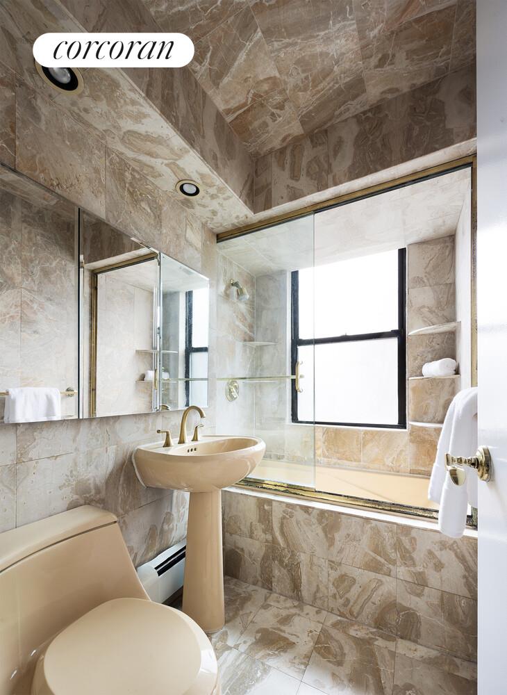 201 East 21st Street, Unit 7S Manhattan, NY 10010 - Photo 11 of 12 a bathroom with a sink mirror toilet and bathtub