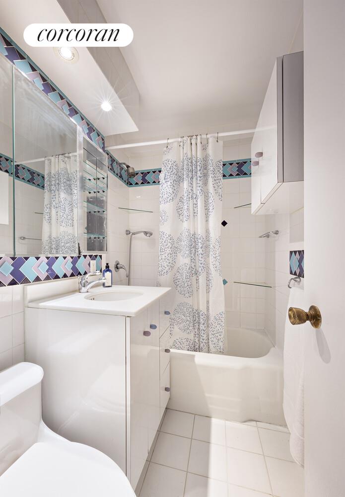 201 East 21st Street, Unit 7S Manhattan, NY 10010 - Photo 9 of 12 a bathroom with a sink a toilet and shower
