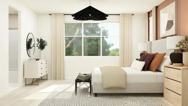 a bedroom with furniture and a large window