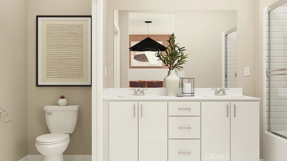 24812 Sirius Avenue Moreno Valley, CA 92551 - Photo 13 of 16 a bathroom with a toilet sink and mirror