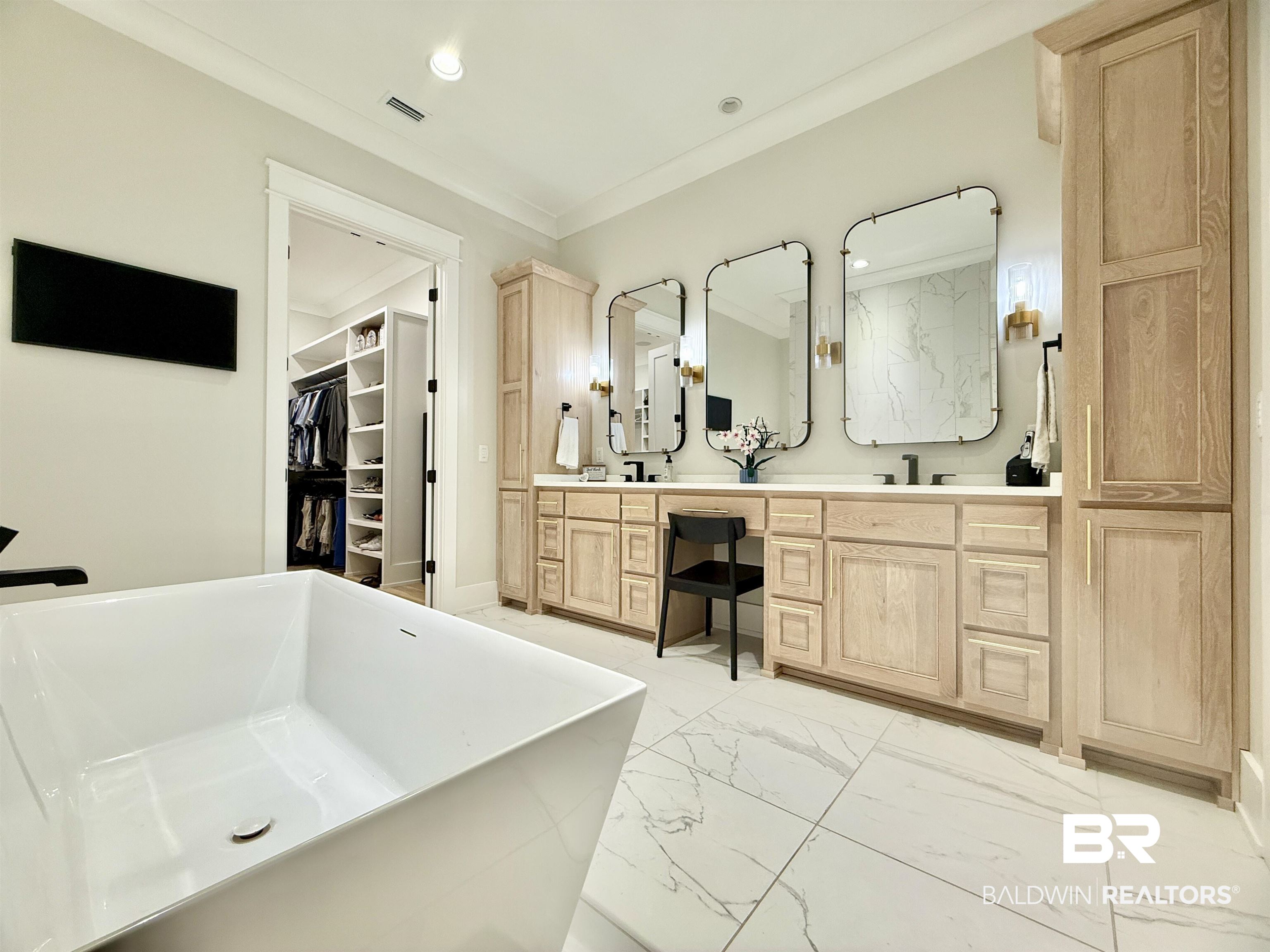 21767 Gallery Boulevard Fairhope, AL 36532 - Photo 29 of 74 Bathroom featuring marble finish flooring, double vanity, a freestanding bath, crown molding, and a spacious closet