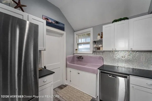 a metallic refrigerator freezer sitting in a kitchen