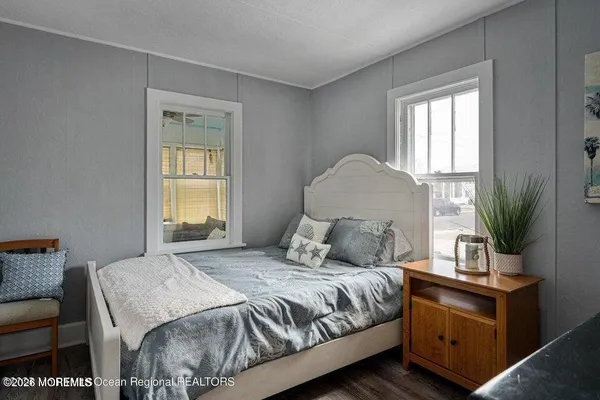 a bedroom with a baby bed and a dresser