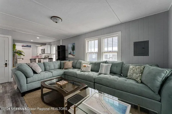 a living room with furniture a rug and a window