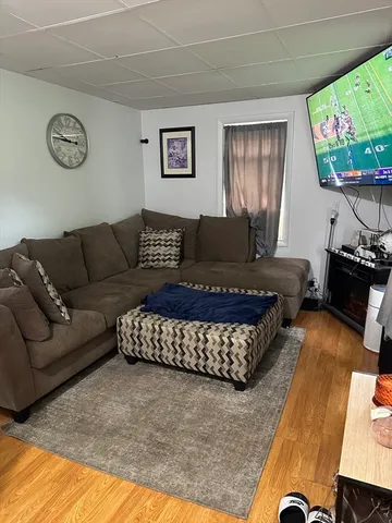 a living room with furniture rug and window