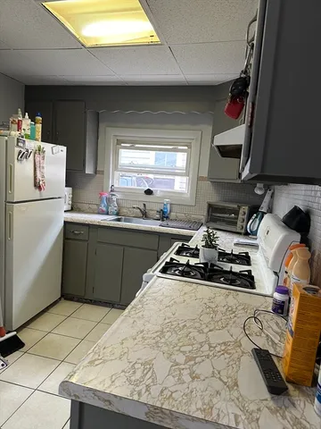 a kitchen with a stove a sink and a refrigerator