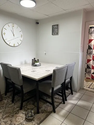 a view of a dining room with furniture and window