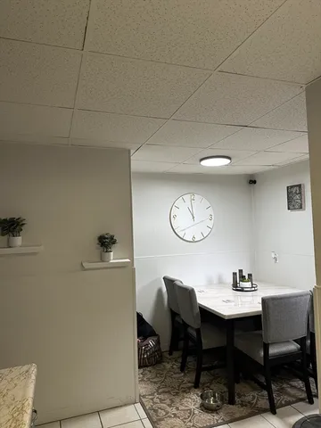 a view of a room with a table and chairs