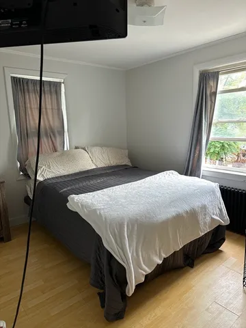 a bedroom with a bed and window