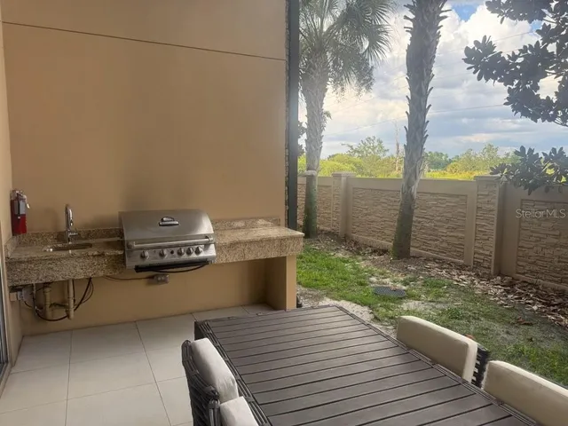 a view of a backyard with sitting area