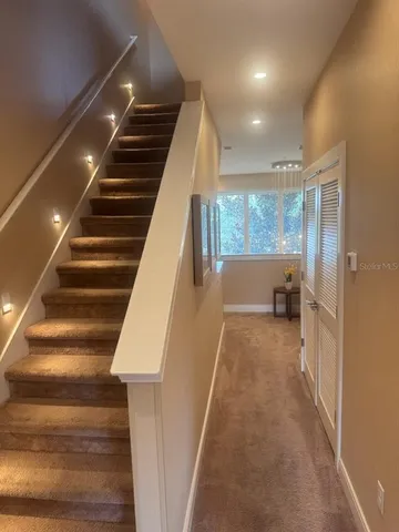 a living room with couches and kitchen view