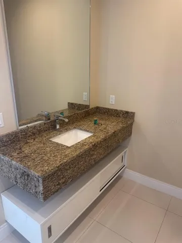 a bathroom with a sink and mirror